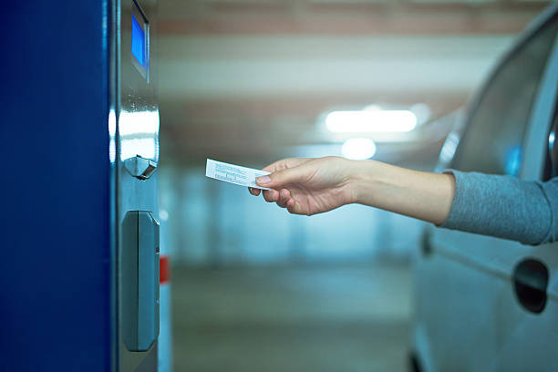 Shot of an unrecognizable driver inserting a ticket into a parking meter