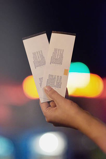 Date night starts here Shot of an unrecognizable person holding up two tickets ticket photos stock pictures, royalty-free photos & images