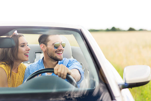istock Happy Couple Driving in Convertible 576606704