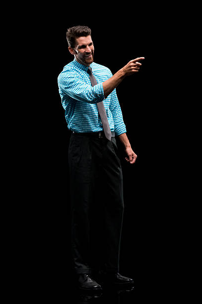 istock Smiling businessman pointing away 576606964