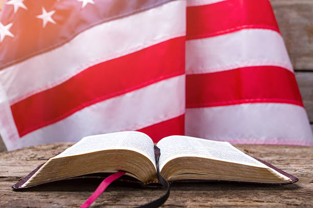istock Opened book and USA flag. 576608248