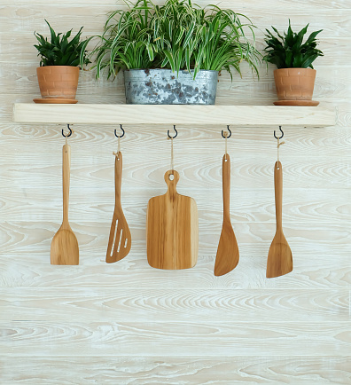 Wooden kitchenware hanging on wall 