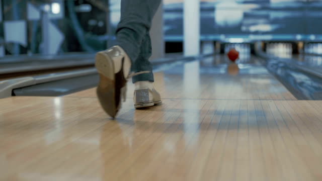 Woman is throwing bowling ball
