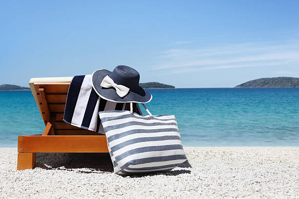 istock sunbed with bag, blue hat and towel on the beach 576710138