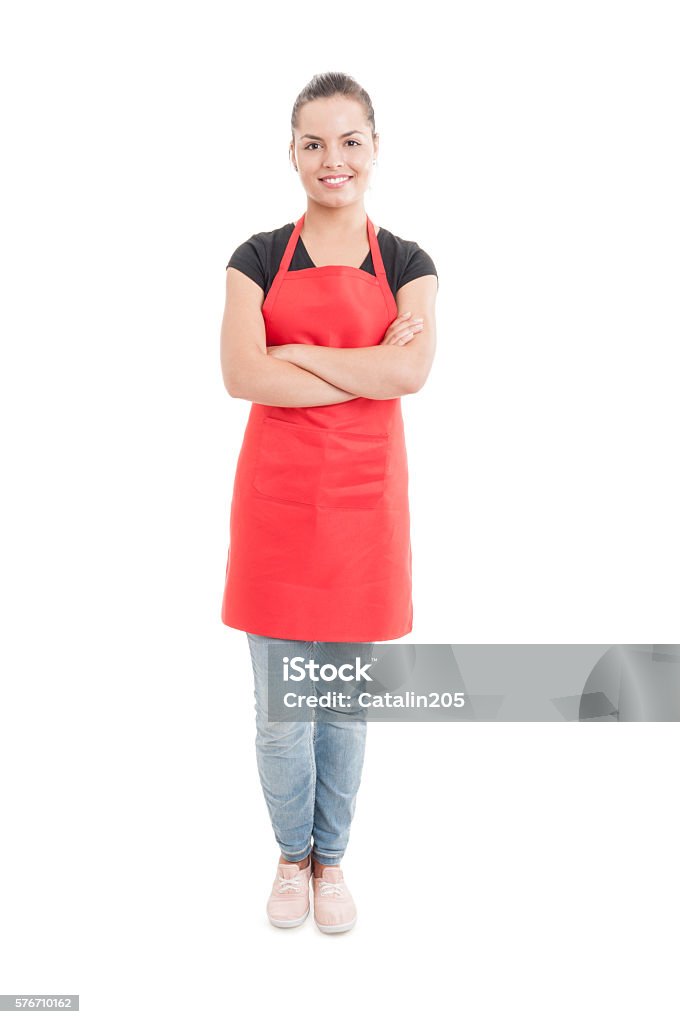 Happy hypermarket seller with confident attitude Happy hypermarket seller with confident attitude standing with folded arms isolated on white background Apron Stock Photo