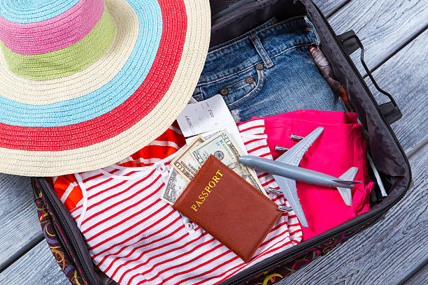 istock Suitcase with clothes and passport. 576710484