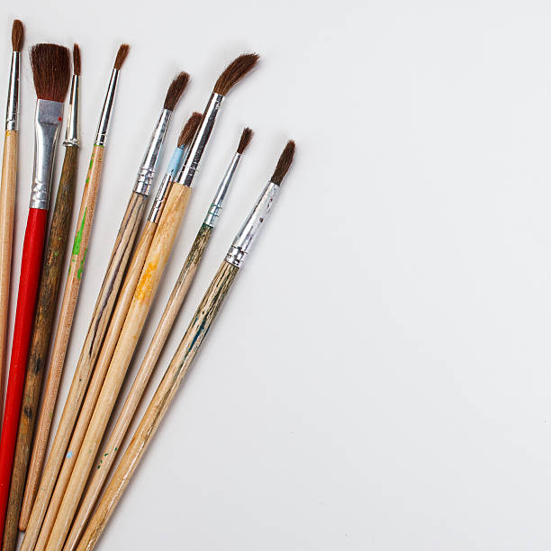 istock brushes for painting  and blank white paper sheet 576711126