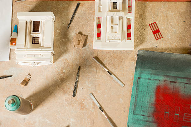 istock Scale Model Buildings, Parts, and Tools on Wooden Table 576711934