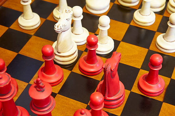 istock Chess pieces in red and white color over the table. 576712006