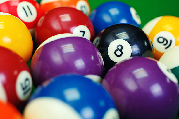 istock billiard balls on a green pool table, closeup 576712714