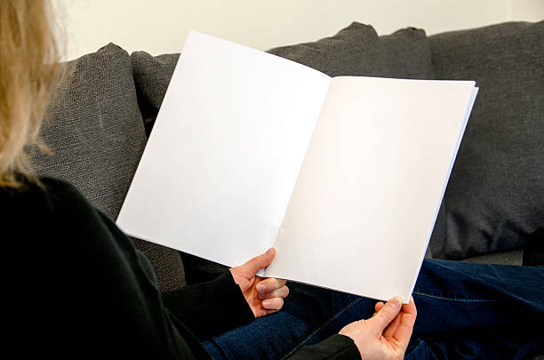istock Sitting and looking at blank brochure with copy space 576715082