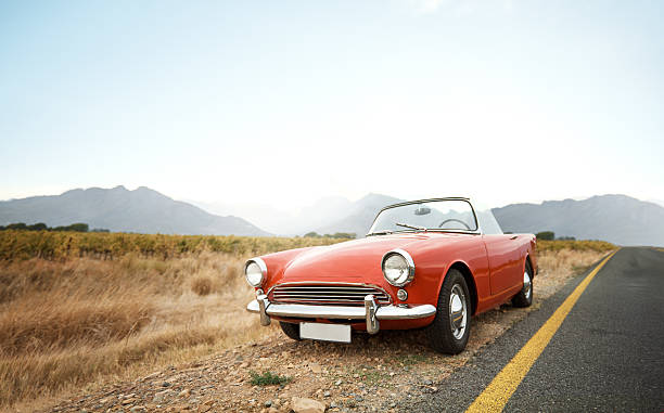 Life’s better in a classic Shot of a vintage car parked on the side of the road convertible photos stock pictures, royalty-free photos & images