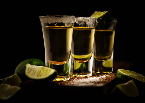 istock Mexican Gold Tequila with lime and salt on wooden table 576716042
