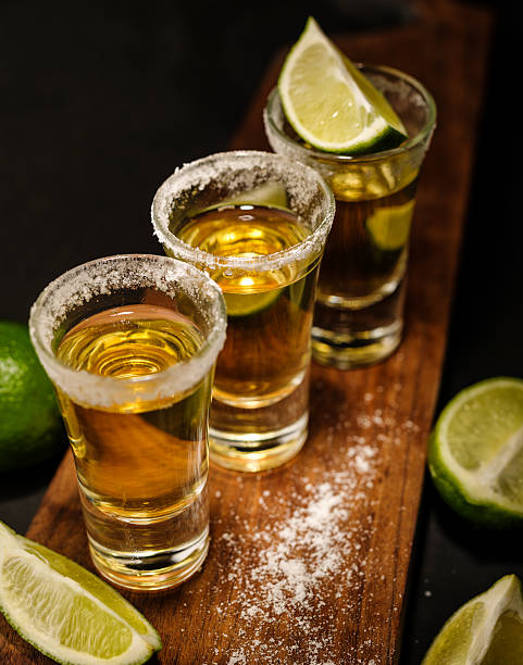 istock Mexican Gold Tequila with lime and salt on wooden table 576716414