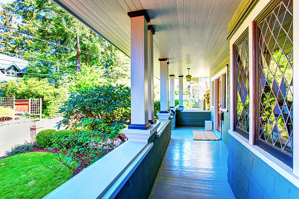 istock Perfect covered front porch with decorative windows, and greenery. 576716484