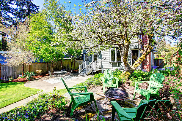 istock Beautiful backyard view with two patio areas and blooming trees. 576717606