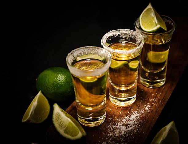 istock Mexican Gold Tequila with lime and salt on wooden table 576718488