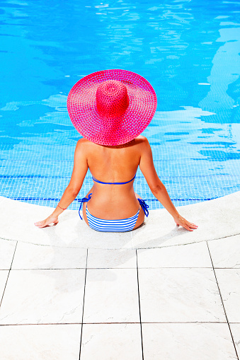 woman relaxing in resort swimming pool
