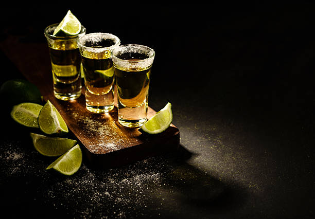 istock Mexican Gold Tequila with lime and salt on wooden table 576718760