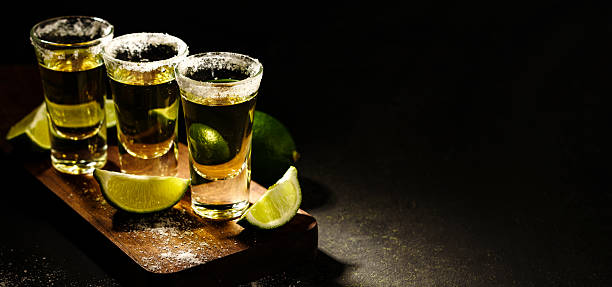 istock Mexican Gold Tequila with lime and salt on wooden table 576718920