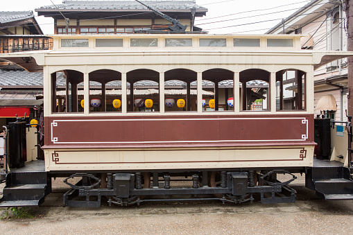 A brown railroad box car on track.