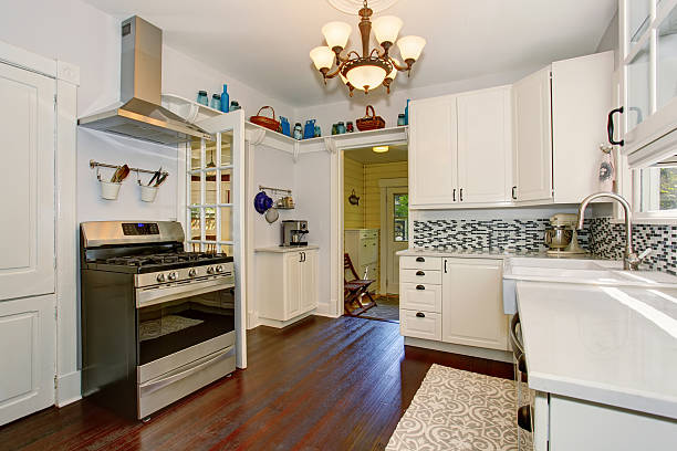 istock Bright kitchen room with white cabinets and hardwood floor. 576719438