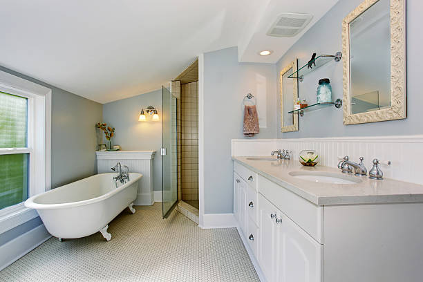 istock Elegant bathroom in pastel blue tones with white bath tub 576719896