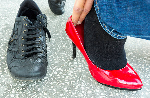 istock Man putting on red ladies shoes 576720442