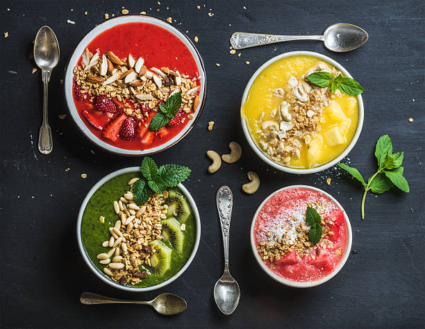 Healthy summer breakfast concept. Colorful fruit smoothie bowls with nuts
