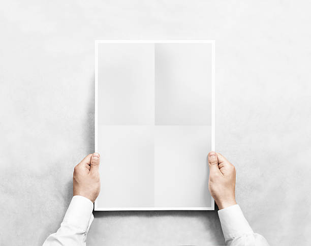 istock Hand holding grey blank poster mockup, isolated. 576720684