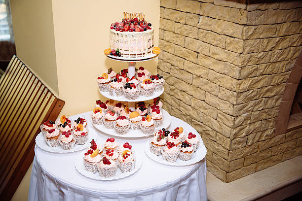 istock Sweet multilevel wedding cake decorated with flowers. Candy bar 576720922