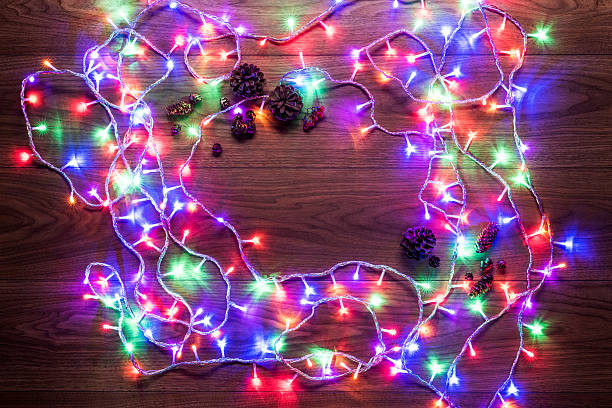 Christmas theme background, xmas lights on wooden table