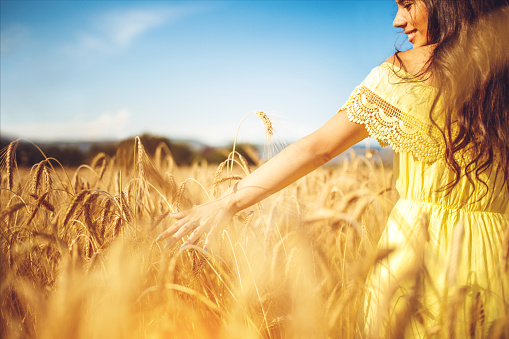 close up picture of young woman in wheat field
