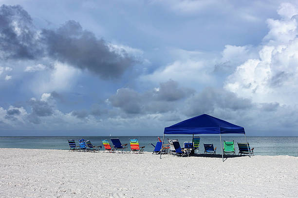 istock Multiple colorful beach chairs on white sand beach 576723910