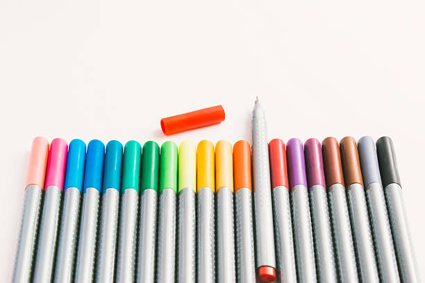 istock Red pen, rainbow magic colour pen on white paper 576724236