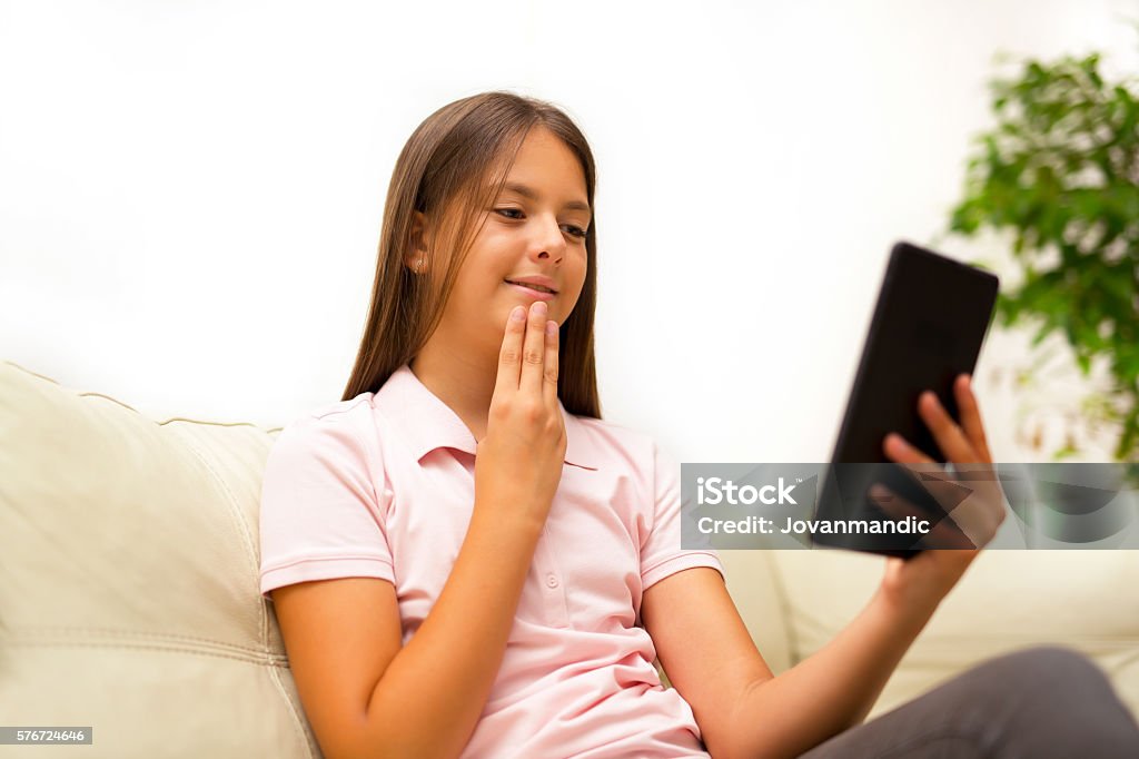 Smiling deaf girl talking using sign language on digital tablet Assistance Stock Photo