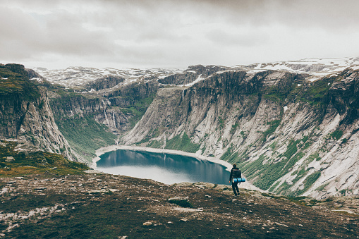 Young Caucasian man hiking in Norway near the lake 