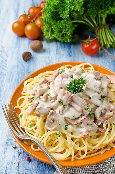 istock Spaghetti with Bechamel sauce, mushrooms and bacon 576725948