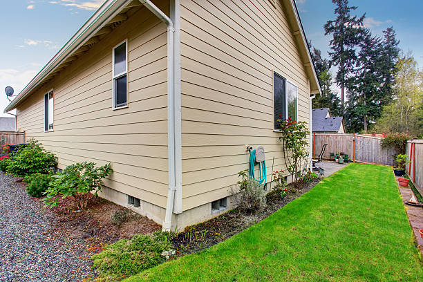 istock House exterior with beige siding. Fenced Back yard 576726502