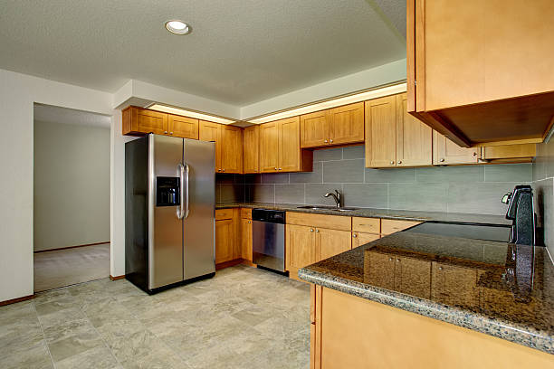 istock Spacious kitchen interior with light tones cabinets and steel appliances 576726802