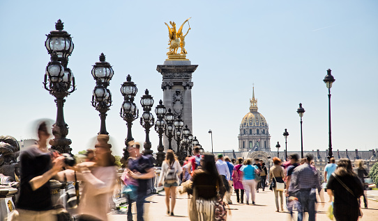 Crowd of tourists on Pont Alexandre III in Paris - unrecognizable persons