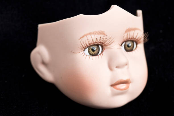 istock Broken Doll Face and Head on Black Background 576731988