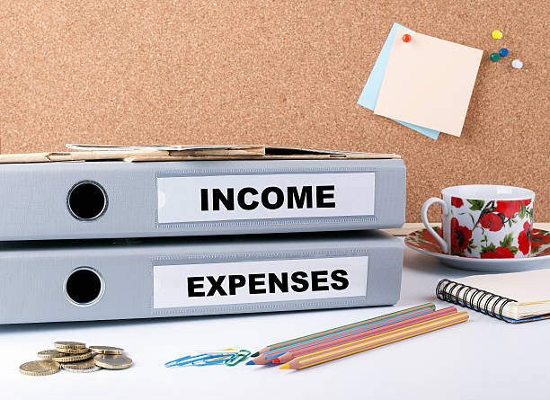 istock Income and Expenses - two folders on white office desk. 576734624
