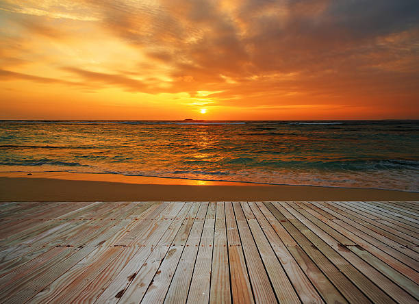 istock Wooden platform beside sunset beach 576735686