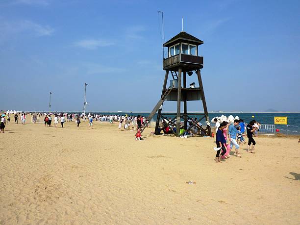 Jinshan, China - June 10, 2016: Local tourists walking at Jinshan, a beach in Shanghai municipality, overlooking Hangzhou Bay.