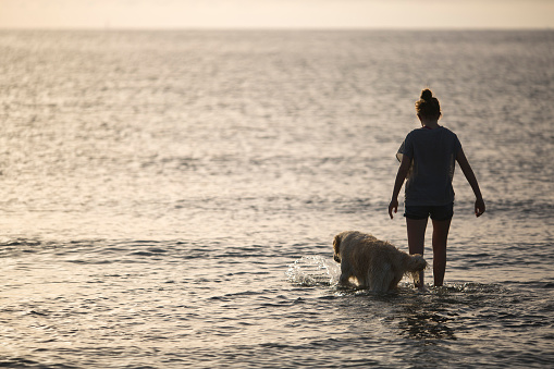 girl in the water with his dog in Santa Pola, Alicante, Spain