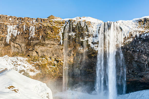 istock Waterfall Seljalandsfoss in winter, reflection in river. Iceland. 576741192