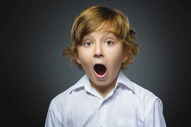 istock Closeup Portrait of handsome boy with astonished expression while standing 576741886
