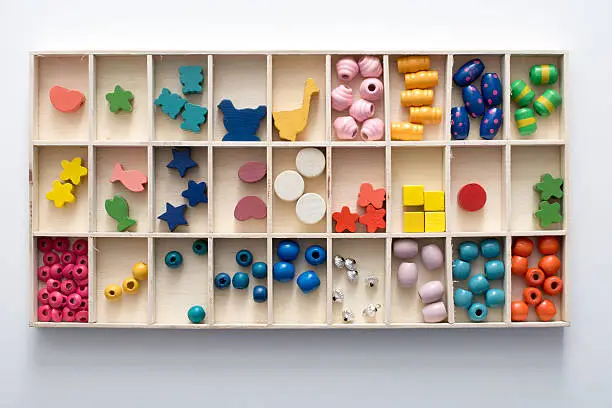 Photo of sorting box filled with wooden beads for beading