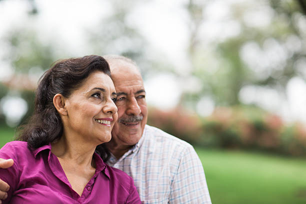 istock Happy senior latin couple looking away 576744822